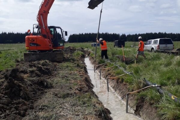 Civil engineering team renewing sewer rising mains with an excavator and deep drainage setup, demonstrating water reticulation systems, storm water solutions, and wastewater reticulation system upgrades for local infrastructure projects.