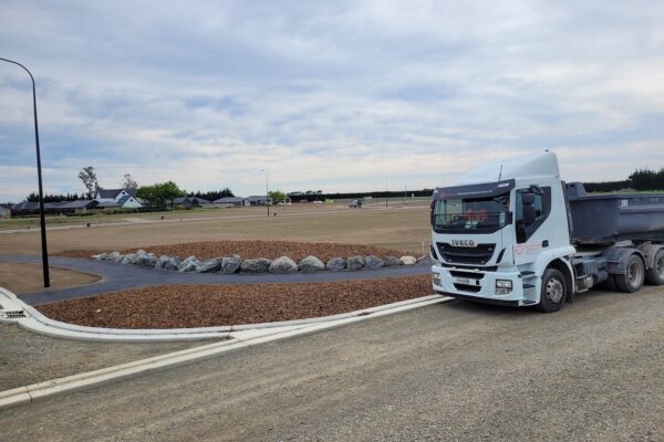 Completed subdivision earthworks and streetscape development featuring kerb and channel, stormwater drainage, and civil work delivered by an earthworks company and civil contractors for residential growth areas.