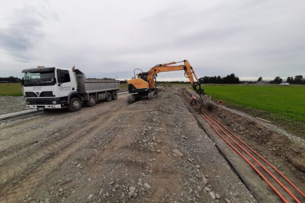 Drone view of large-scale subdivision earthworks, showing roads under construction, drainage installation, storm water systems and land shaping for a new residential development in Canterbury.