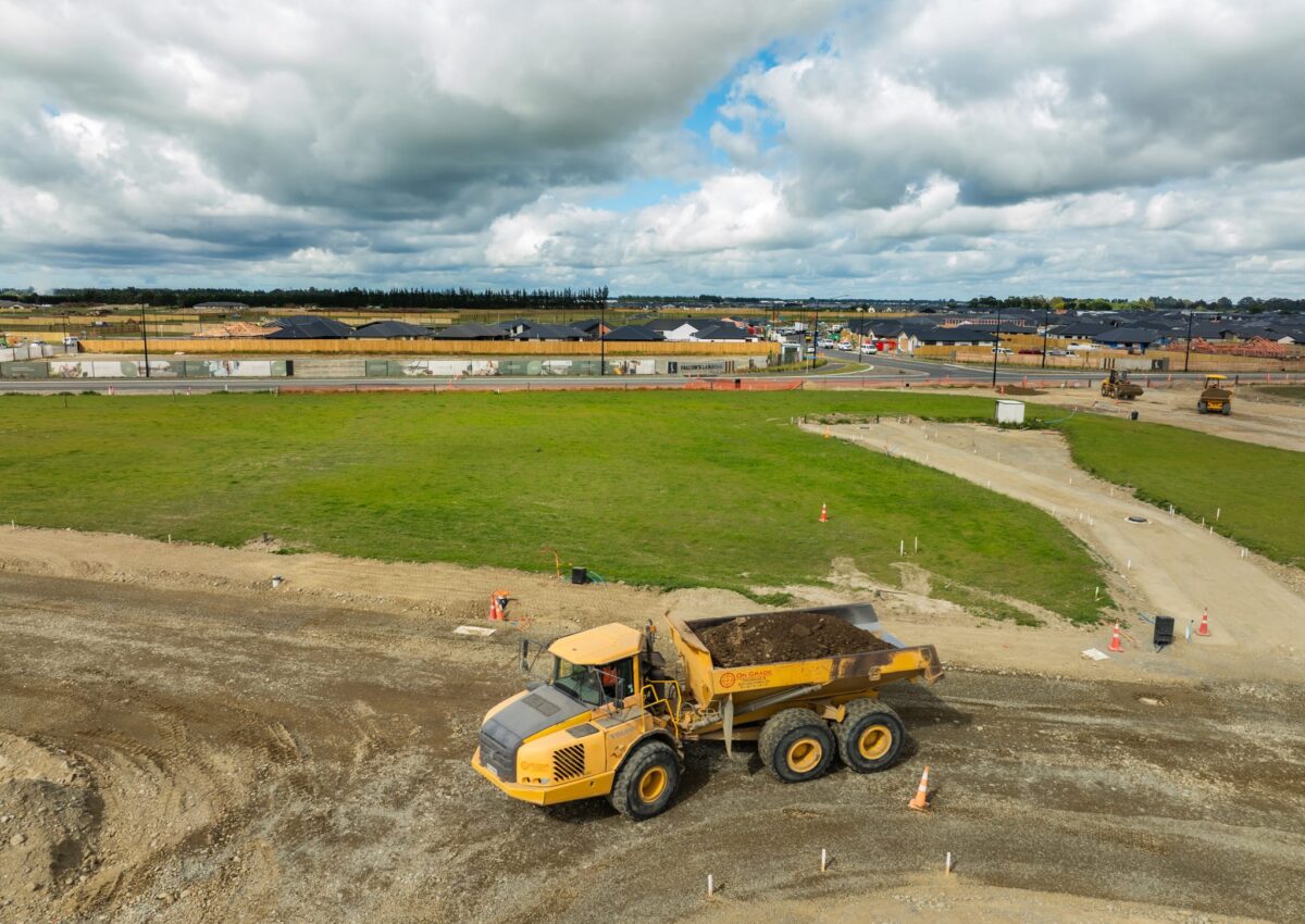Articulated dump truck transporting soil as part of large subdivision earthworks, roading preparation, stormwater systems installation and civil work for a civil engineering company and construction contractors in Canterbury.