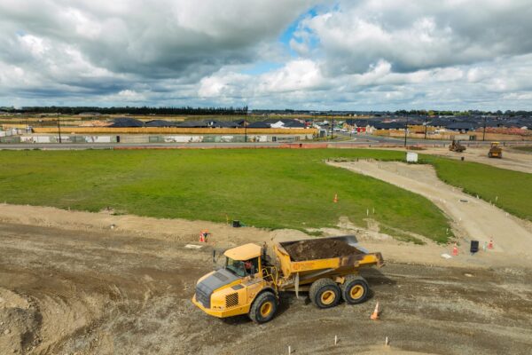 Articulated dump truck transporting soil as part of large subdivision earthworks, roading preparation, stormwater systems installation and civil work for a civil engineering company and construction contractors in Canterbury.