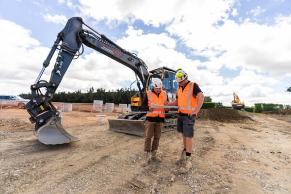 Civil engineers working with surveying tools to confirm ground levels for stormwater systems, deep drainage, water reticulation and wider civil construction works.