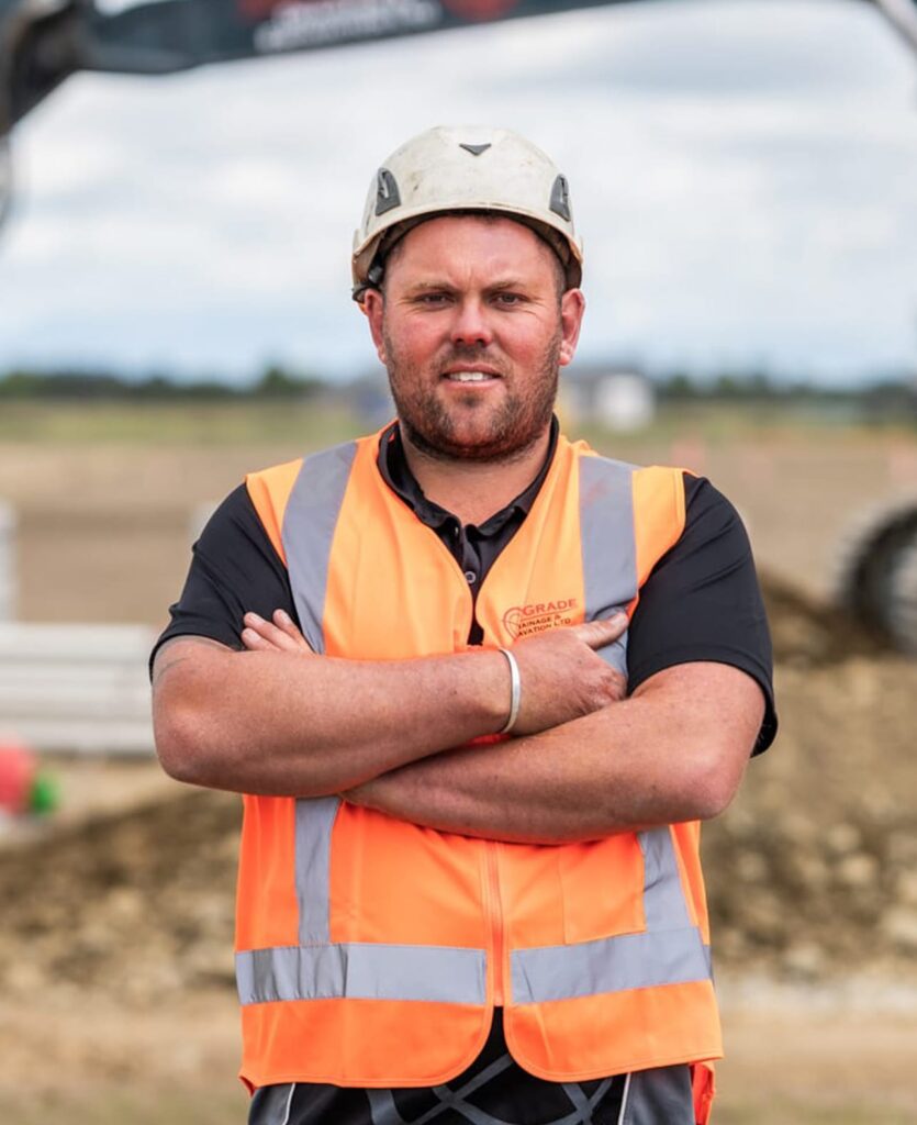 Construction worker in high-vis gear on a civil construction site, representing civil contractors Christchurch completing deep drainage, stormwater drainage, sewage treatment plant support, wastewater treatment system installation and general civil work.