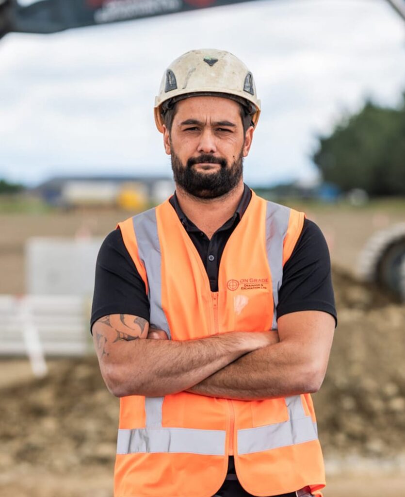 Construction contractor wearing high-vis uniform on a worksite, demonstrating civil construction services, storm drain installation, wastewater reticulation system work, deep drainage, blocked storm water drain repair and storm water solutions