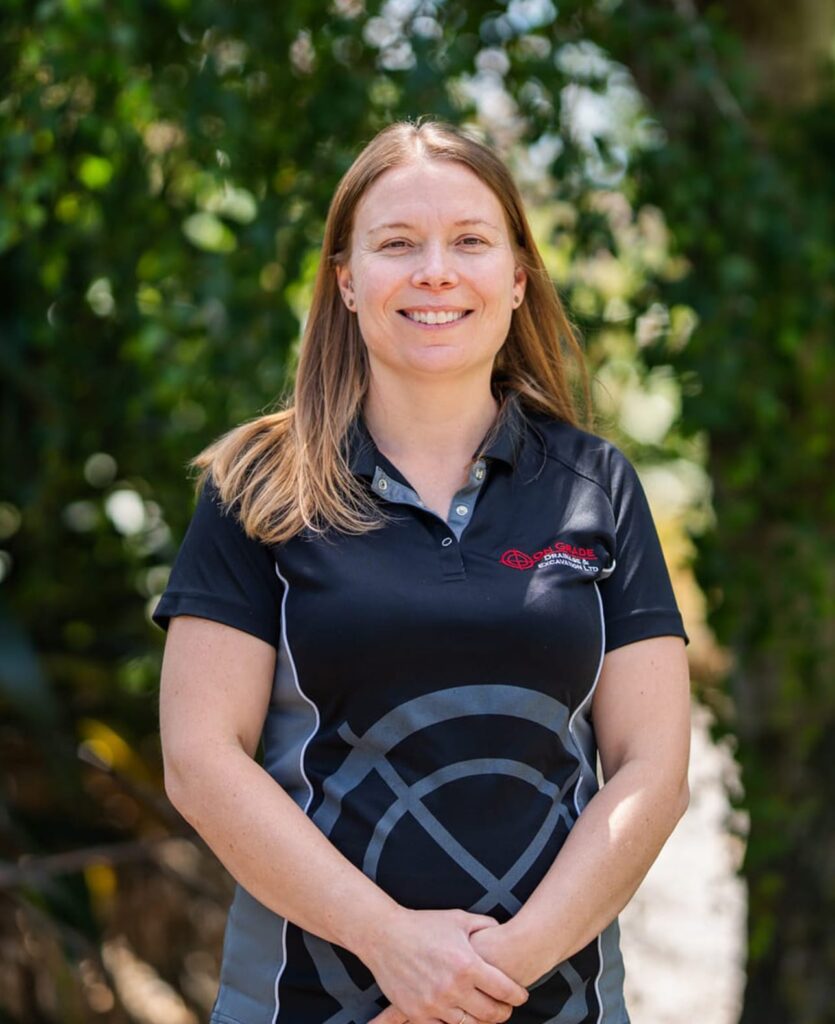 Staff member in branded uniform standing outdoors, showing civil construction company capability including land excavation, stormwater systems, storm water drainage system work, wastewater reticulation, water treatment and civil contractors Christchurch services.